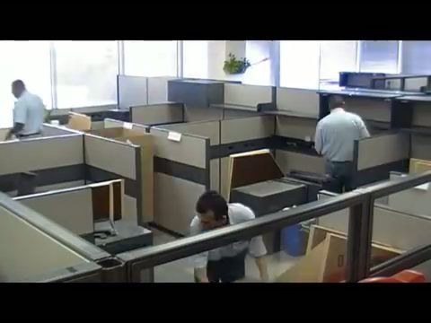 crew of movers reconfiguring office cubicles